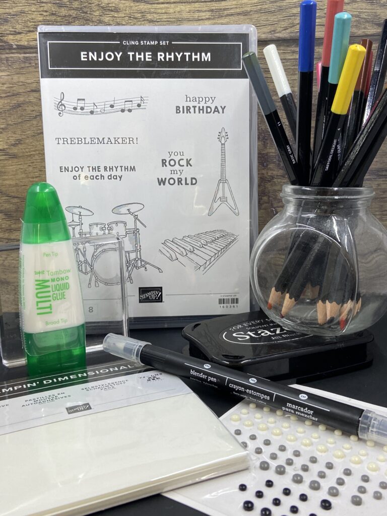 All the supplies you will receive in the Enjoy the Rhythm class (deadline to sign up is April 5, 2023): Enjoy the Rhythm stamp set, Black Staz On Ink, a clear D Block, Watercolor Pencils, Blender Pen, Classic Matte Dots, Multipurpose Liquid Glue, a pack of Dimensionals. All supplies can be used on future projects.